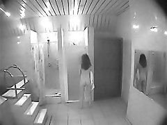 Girl takes a shower unsuspecting of spy cam
