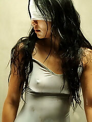 Asian girl in spandex body suit tied and bound.