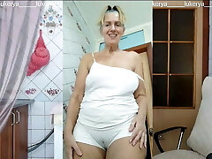 Lukerya in the kitchen in humid white panties, bottom view
