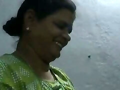 Mature and happy Indian aunty giving oily handjob on web cam