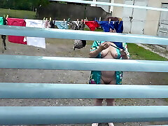 Naked in public. Neighbor saw pregnant neighbor in window who was drying clothes in yard without bra and underpants. Nudist