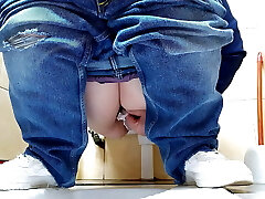 Sizzling MILF in jeans pissing in a public restroom
