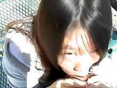 Asian woman sucking guys in the park in broad day light