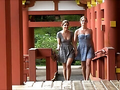 Sapphic couple kissing and flashing at a Japanese temple