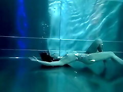 Bond Girl, underwater stunts, nerd nymph, high high-heeled shoes glamor and underwater swimming retro style 