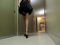 Sissy Ray in hotel corridor dressed in maids uniform