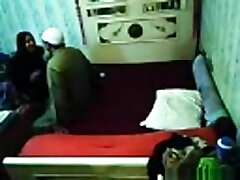 Voyeur tapes an arab hijab girl having missionary sex with a stud on the bed
