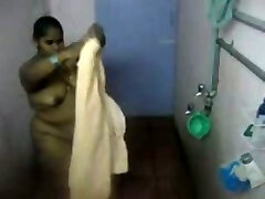 Fat Indian girl washes her body in the bathroom in covert cam clip