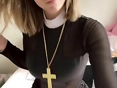 Pious girl with a cross shows her bosoms and pussy