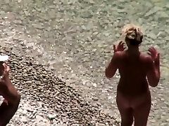 Handjob on candid beach with old nudist couple
