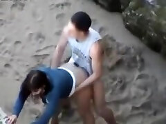 Nubiles doggy style on the beach