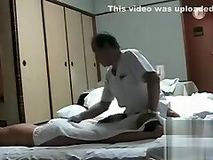 My bare wife gets massage from an Asian man
