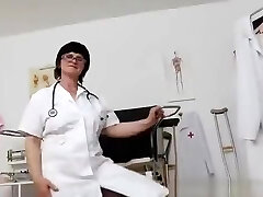 Brunette practical nurse examining her vulva