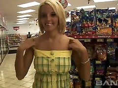Cute blonde haired female flashes her pierced pussy in the shop