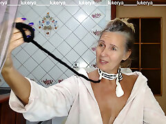 Red-hot hostess Lukerya in the kitchen in a dressing gown.