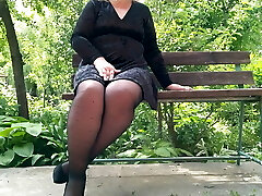 Naughty milf in stocking urinating in the park on a bench – rear view