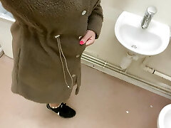 Trendy pisses in the sink in the disabled public toilet