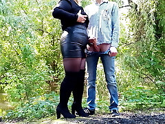 Cougar in leather mini-skirt gets a load on her ass outdoors