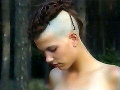 Skinny and tall goth girl with two wild men in the forest