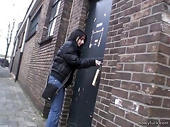 Throating a cock through a glory hole after toying with her snatch