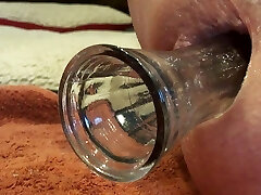 Close up anal insertion gape toy faux-cock butt plug