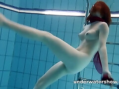 Red-haired Mia stripping underwater Red-haired Mia stripping underwater