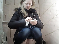 Succulent pallid skin blonde teen in blue jeans urinates in the toilet