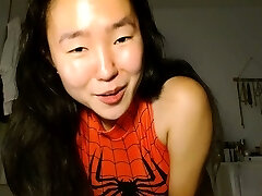 Shaved Asian milf squirting while wank on webcam