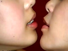 Two Japanese nymphs are doing some weird kissing with a mouth speculum