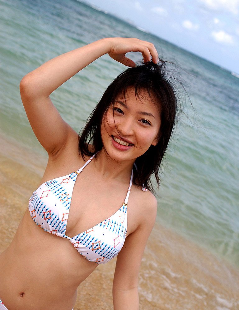 768px x 994px - Japanese girl with a hairy pussy poses in the sun at the beach in her bikini and kneels in the sand with her legs spread.