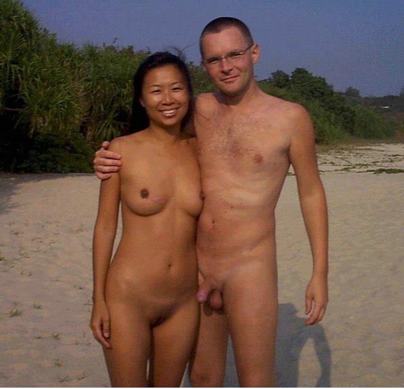 Topless Asian Friends - Nude teen friends play around at a public beach