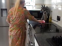 Naughty housewife cleaning in the kitchen