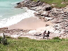 una morena bronceada lleva a un negro a la playa para follarle el apretado coño