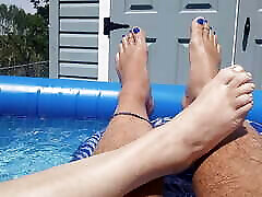 Showing off our pedicured toes in the back yard pool