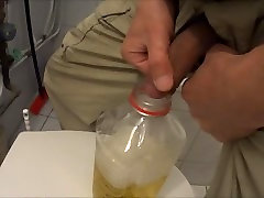 Two friends pissing in one bottle peeing