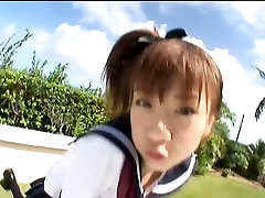 Japanese teen Aki Hoshino plays outside in the sailor outfit