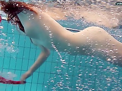Red haired girl Libuse swimming in a pool in fire woska double anal dress