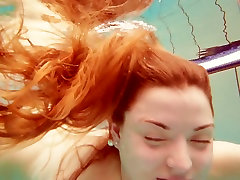 Sizzling redhead model hd panu maya kha swimming naked in a pool