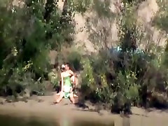 Voyeur tapes a couple having boobs riding dick in public on the side of the river