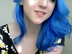 Blue haired girl in flowers plays with tits