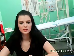 Doctor remaje cute brunette in an office in fake hospital