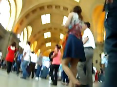 Voyeur underskirt video of a brunette woman on the station