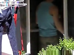 Voyeur films hot chick through her kitchen window