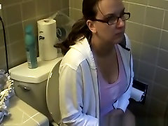 Busty woman in bathroom prison caneing peeing