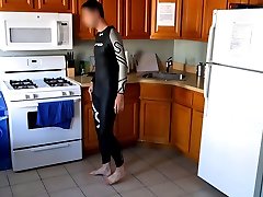 Bulge in Orca wetsuit posing in kitchen