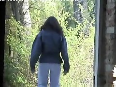 Woman pissing in old building