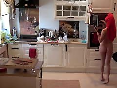 Naked and preparing food in the kitchen