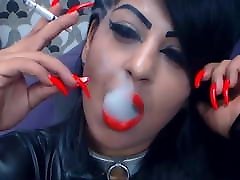 Smoking with red lips and screllet sex nails