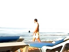 Couple Fools Around in the Water on a Public Beach