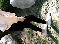 चीनी लड़की सफेद टखने मोजे और काले लेगिंग में पैर मोच